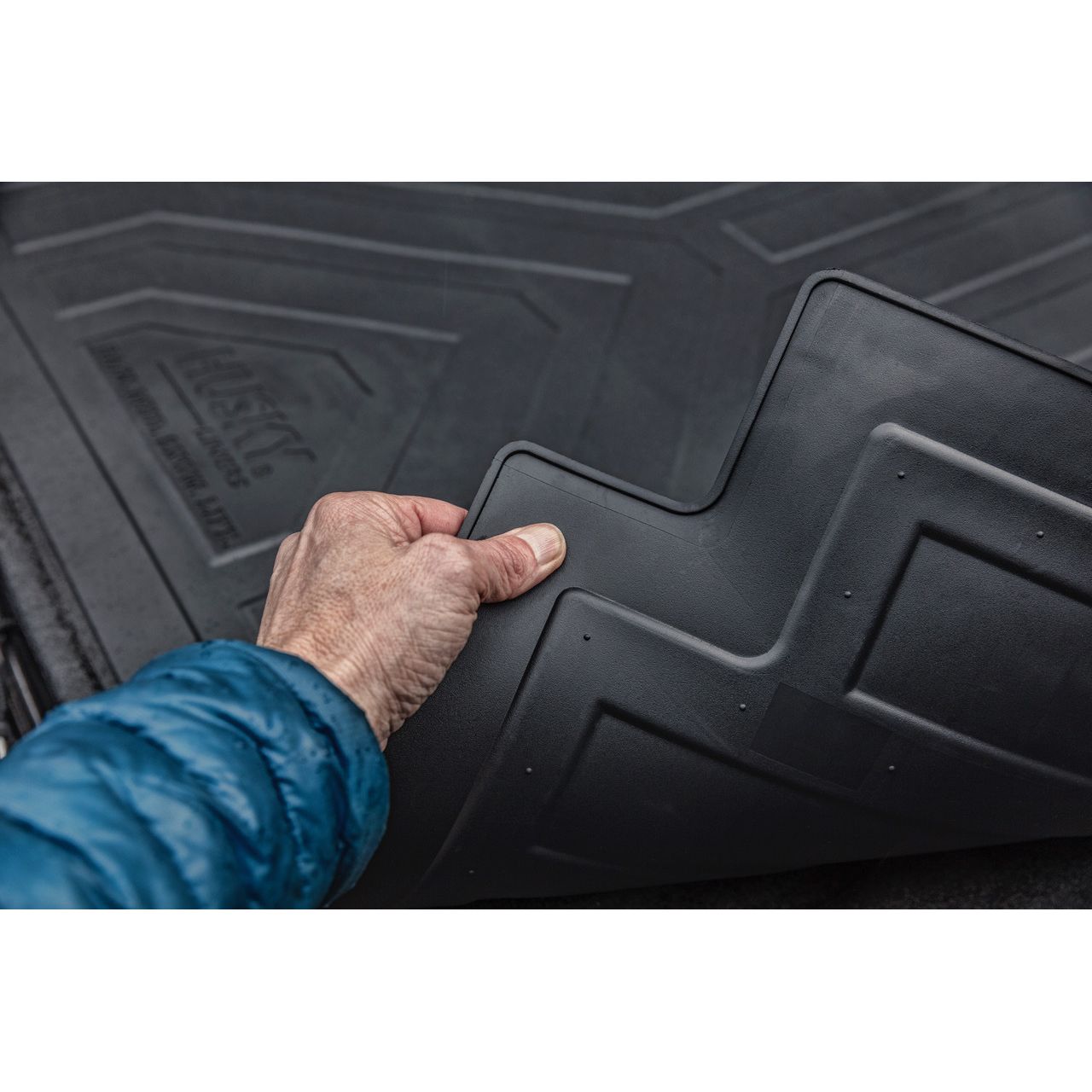 Husky Liners | Truck Bed Mat Heavy Duty Bed Mat For 2015-2024 F-150 Husky Liners | 16009 close-up with hand