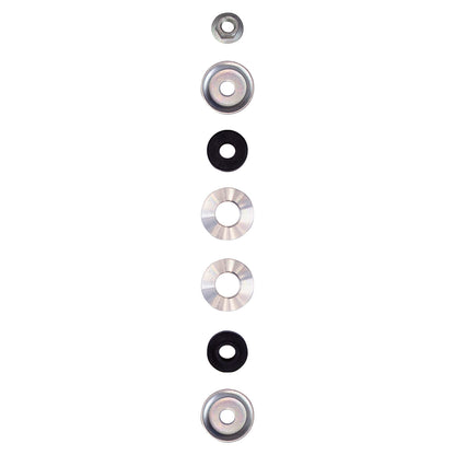 Various metal and rubber washers and nuts arranged vertically, used in automotive suspension systems.