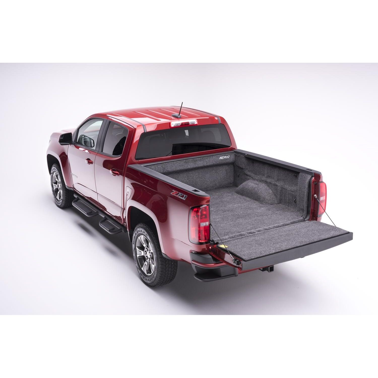 BedRug 15-22 Colorado/Canyon Crew Cab 5' Bed Liner w/ Tailgate Mat - Charcoal (BRB15CCK) installed in red truck bed.