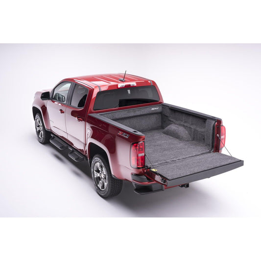 BedRug 15-22 Colorado/Canyon Crew Cab 5' Bed Liner w/ Tailgate Mat - Charcoal (BRB15CCK) installed in red truck bed.