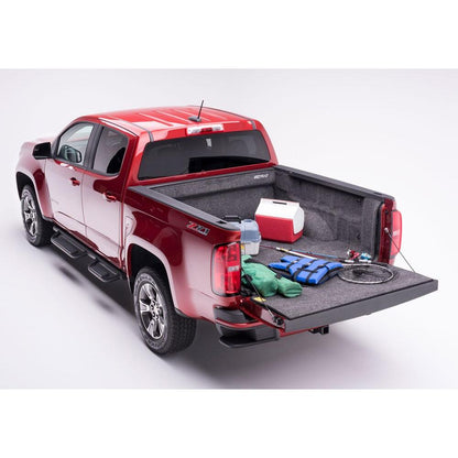BedRug 15-22 Colorado/Canyon Crew Cab 5' Bed Liner w/ Tailgate Mat - Charcoal (BRB15CCK) shown in red truck bed with gear.