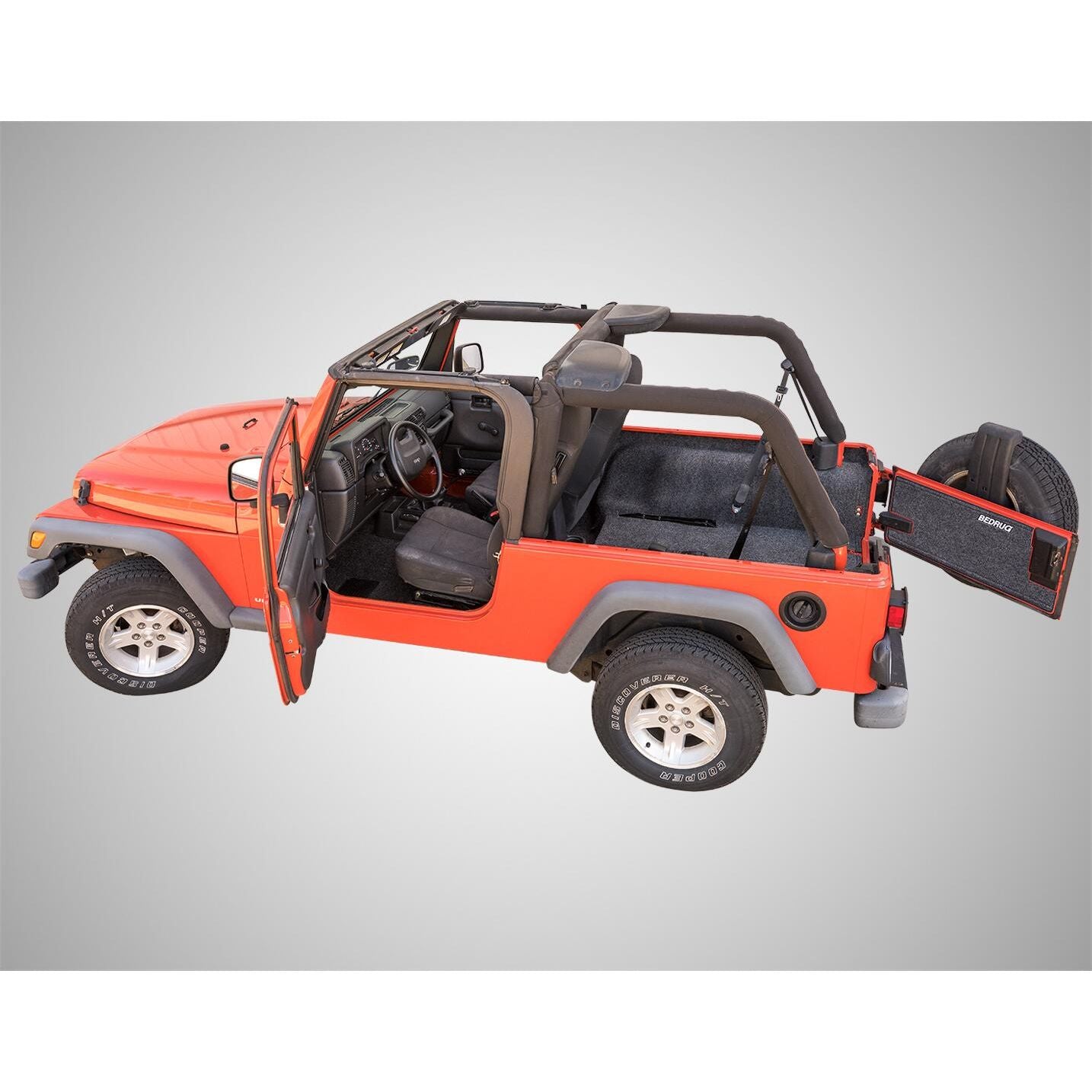 BedRug Jeep 03-06 Jeep LJ Unltd Rear 4Pc Cargo Kit - Charcoal installed in orange Jeep Wrangler with rear cargo area visible.