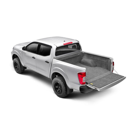 BedRug 04+ Nissan Titan Crew Cab 5.5' Bed Liner w/ Tailgate Mat - Charcoal (BRN04CCK) installed in a silver Nissan Titan.