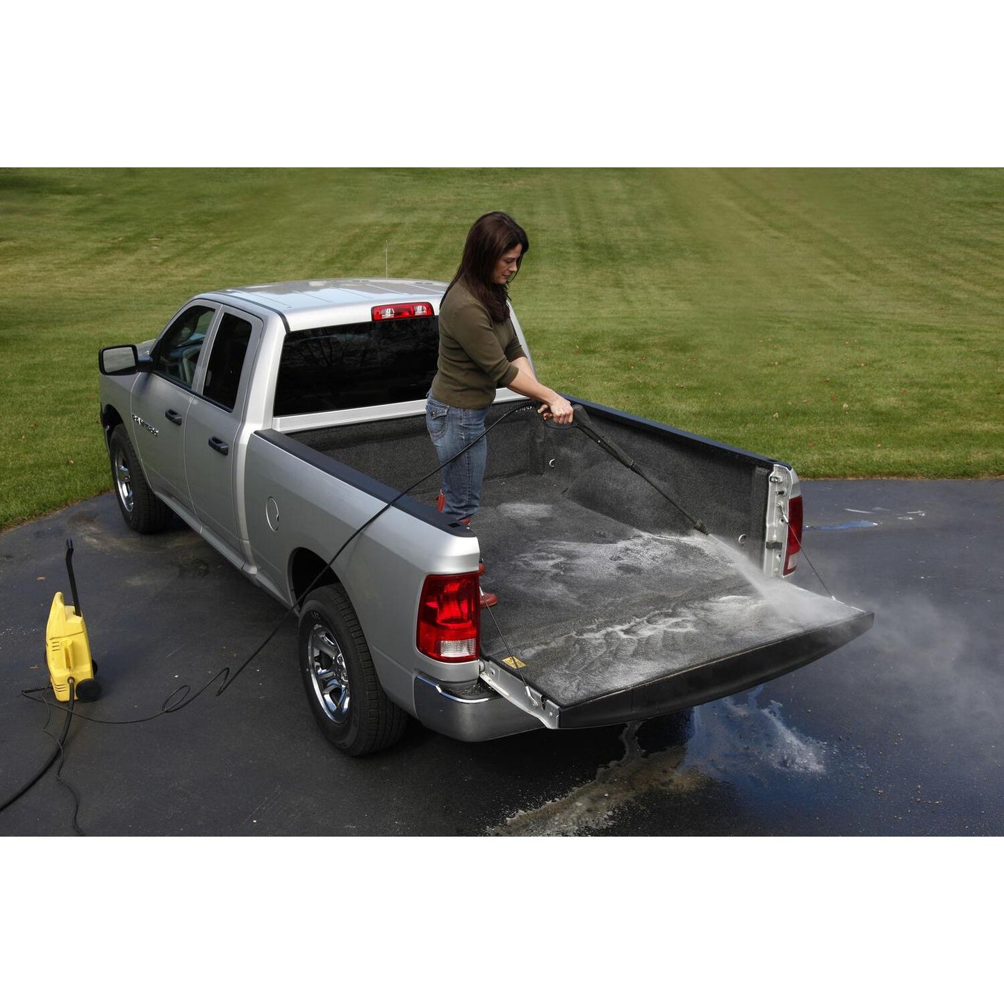 Woman cleaning the BedRug 2019-2025 Ram 1500 6'4" Bed Liner w/ Tailgate Mat w/o RamBox w/o Multifunction Tailgate - Charcoal (BRT19SBK).