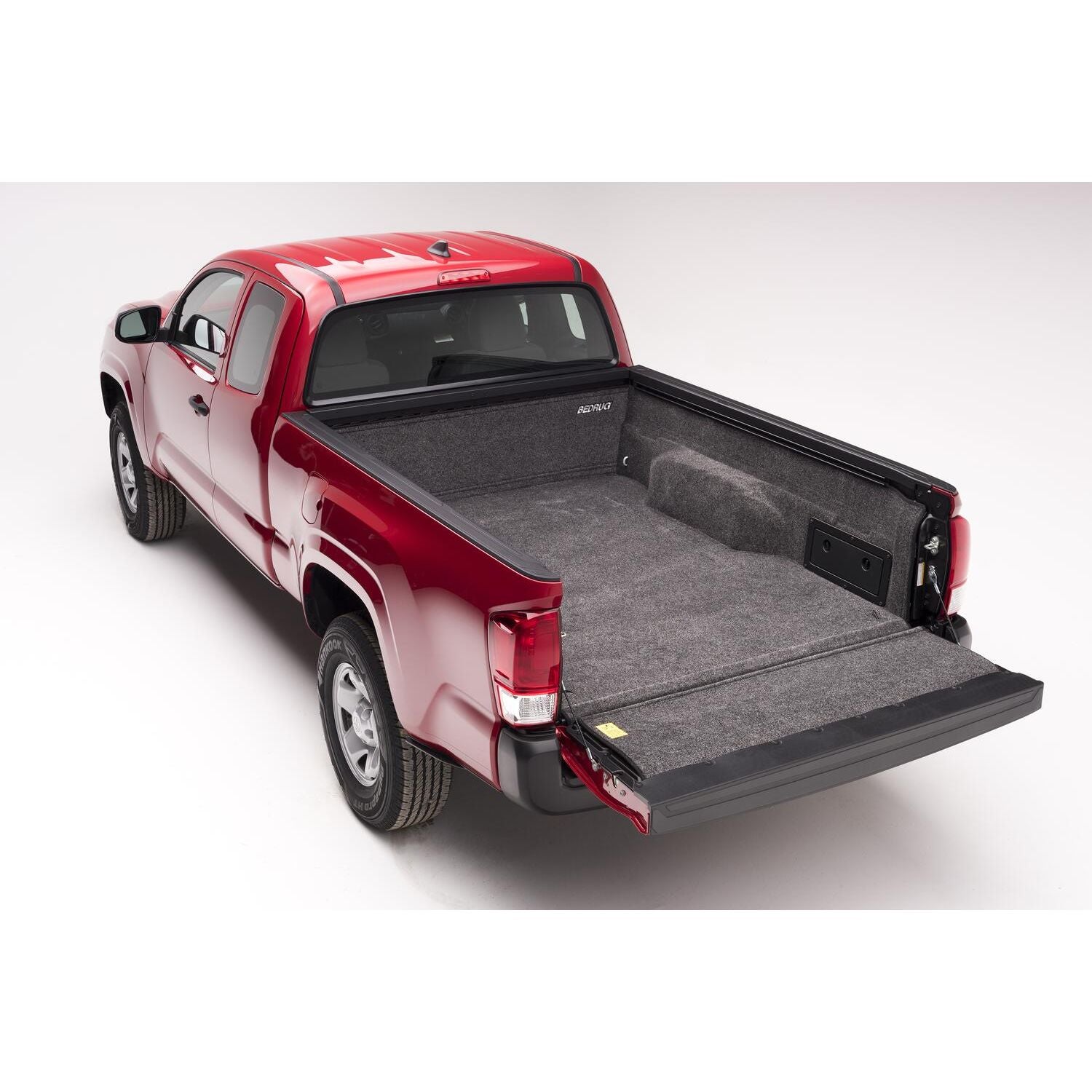 BedRug 05+ Toyota Tacoma 5' Bed Liner w/ Tailgate Mat - Charcoal (BRY19DCK) installed in a red Toyota Tacoma truck bed.