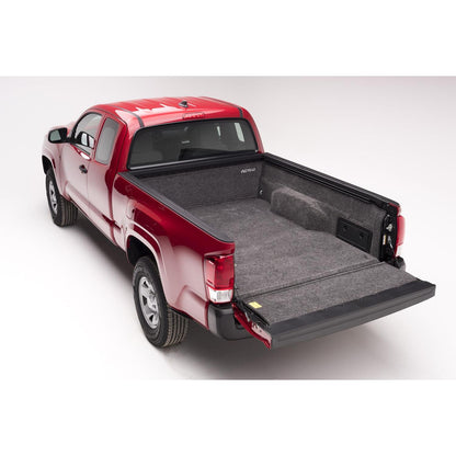 BedRug 05+ Toyota Tacoma 5' Bed Liner w/ Tailgate Mat - Charcoal (BRY19DCK) installed in a red Toyota Tacoma truck bed.