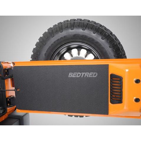 BedRug Jeep Tailgate Bedtred 87-95 Jeep YJ Tailgate Mat - Charcoal (BTYJTG) installed on tailgate with tire.