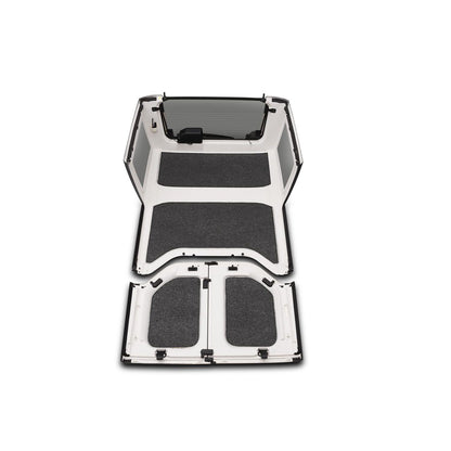 BedRug 2018-2026 Jeep Wrangler 4 Door Bed Liner - Charcoal (HLJL184DRK) installed in a Jeep Wrangler interior.