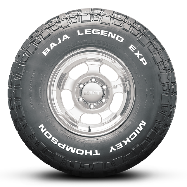 Mickey Thompson Tires BAJA LEGEND EXP with silver rim, showcasing all-terrain performance for trucks and SUVs.