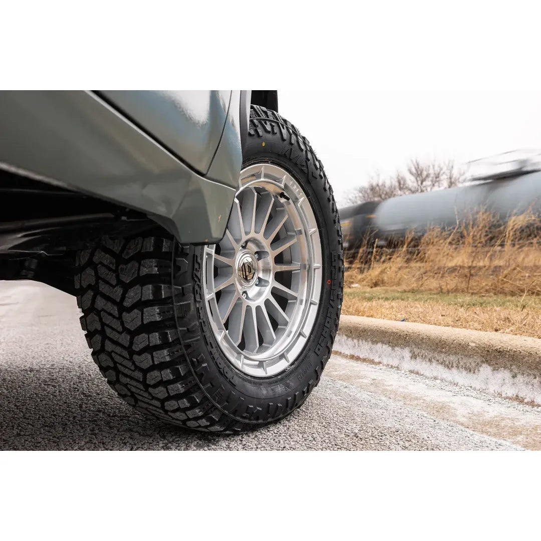Close-up of AVIX Trailtek R/T Tires on a vehicle, showcasing rugged tread design for off-road and pavement use.
